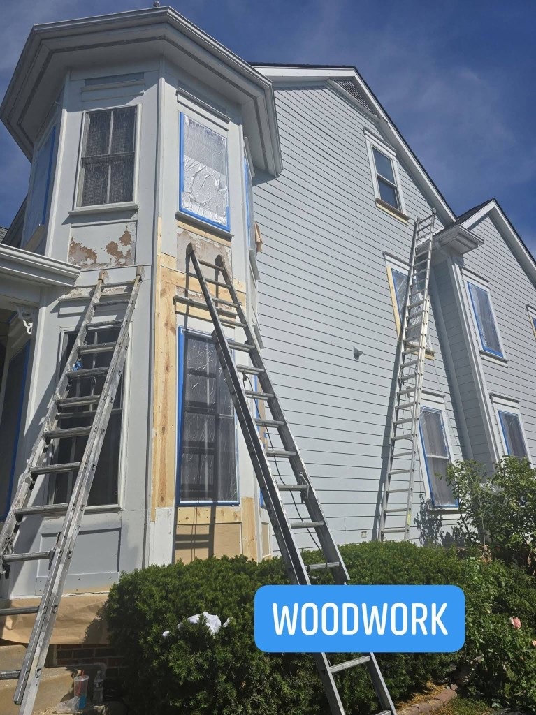 Wood rot repair in progress - new wood installed around bay windows