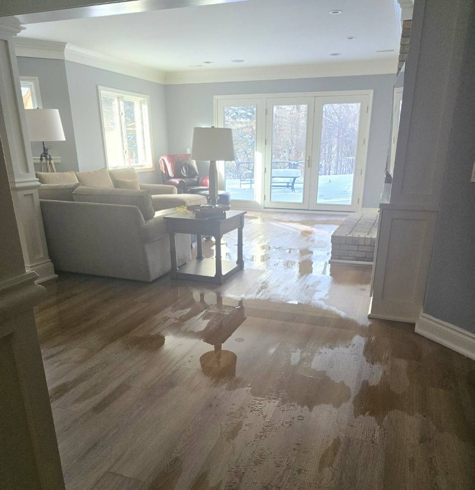 Flooded basement with standing water from sump pump overflow in a Michigan home